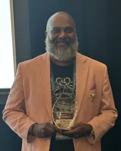 Suresh Rachuri holding his 2026 Smart Business Dealmaker of the Year award