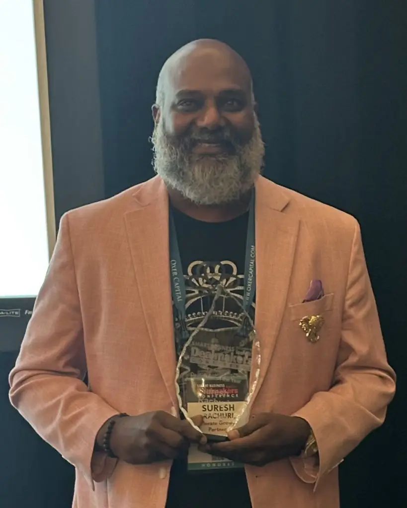 Suresh Rachuri holding his 2026 Smart Business Dealmaker of the Year award